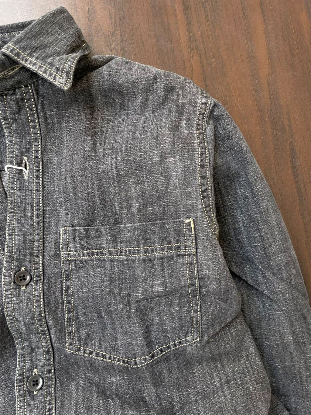 Light grey acid-wash denim shirt with single chest pocket and buttoned cuff