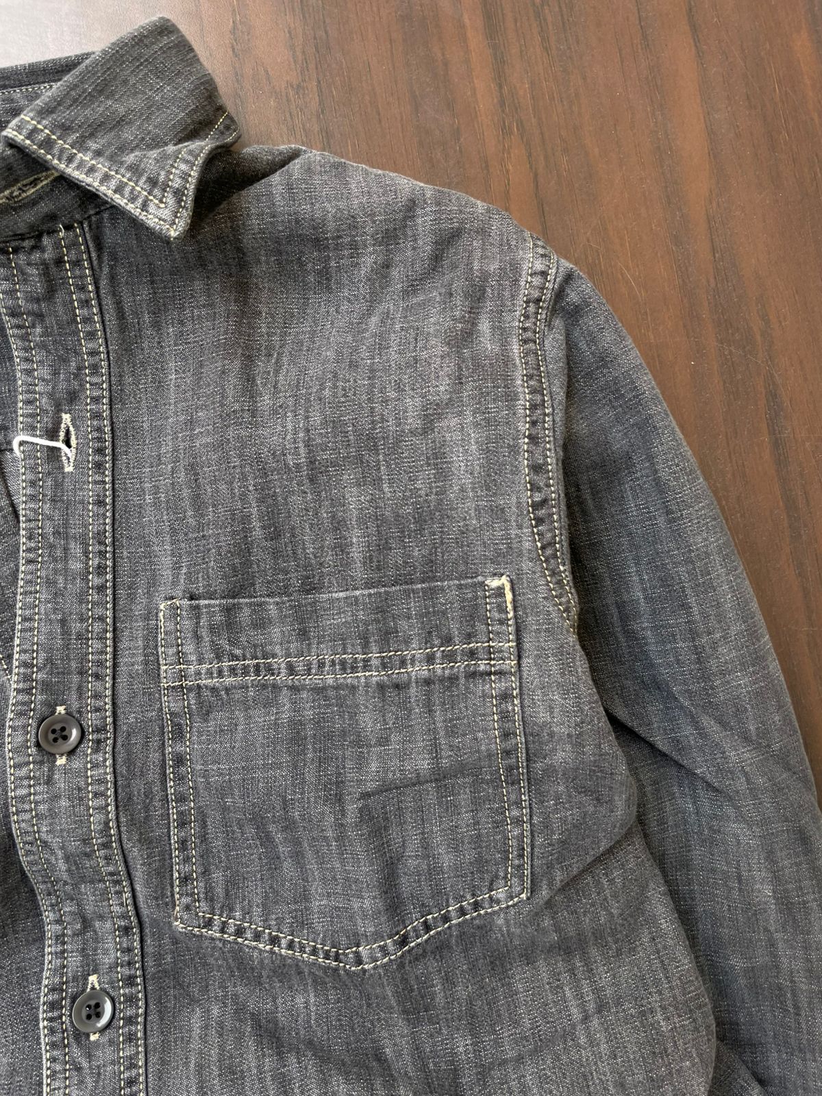 Light grey acid-wash denim shirt with single chest pocket and buttoned cuff