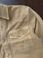 Tan beige denim western shirt chest pocket with flap and button; logo patch on pocket