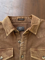 Tan-brown denim shirt collar and button placket with brand labels and snap front.