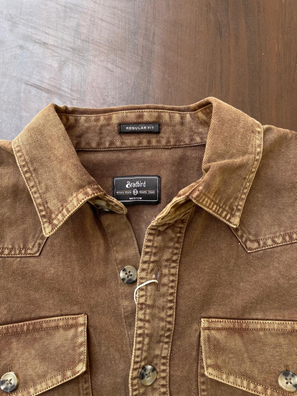 Tan-brown denim shirt collar and button placket with brand labels and snap front.