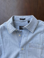 Powder blue denim half-sleeve shirt close-up of collar, button placket, chest pocket