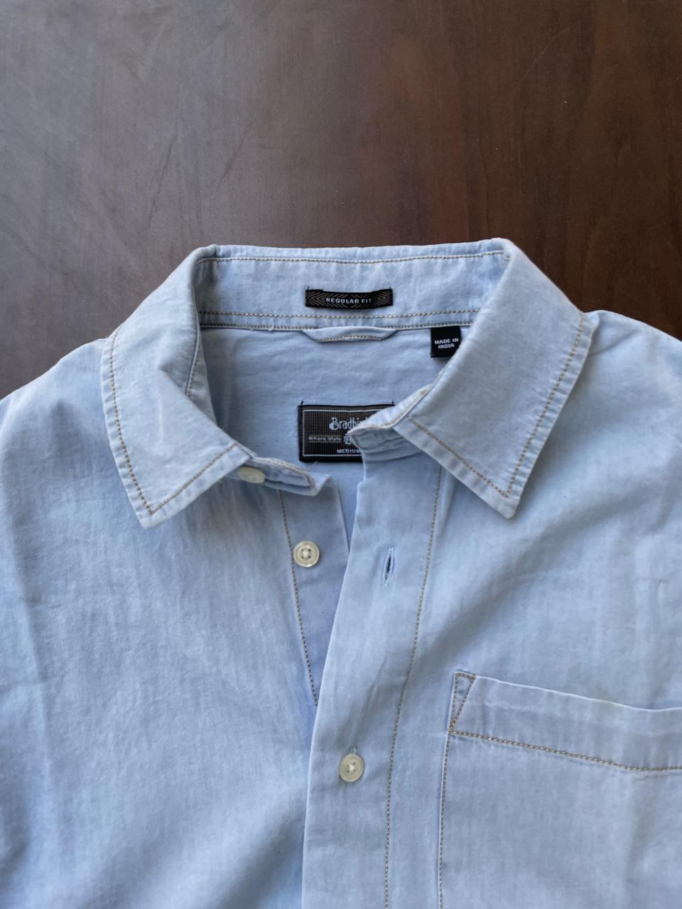 Powder blue denim half-sleeve shirt close-up of collar, button placket, chest pocket