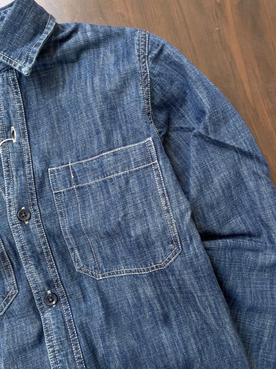 Stonewash indigo denim shirt side pocket with contrast topstitching and button detail