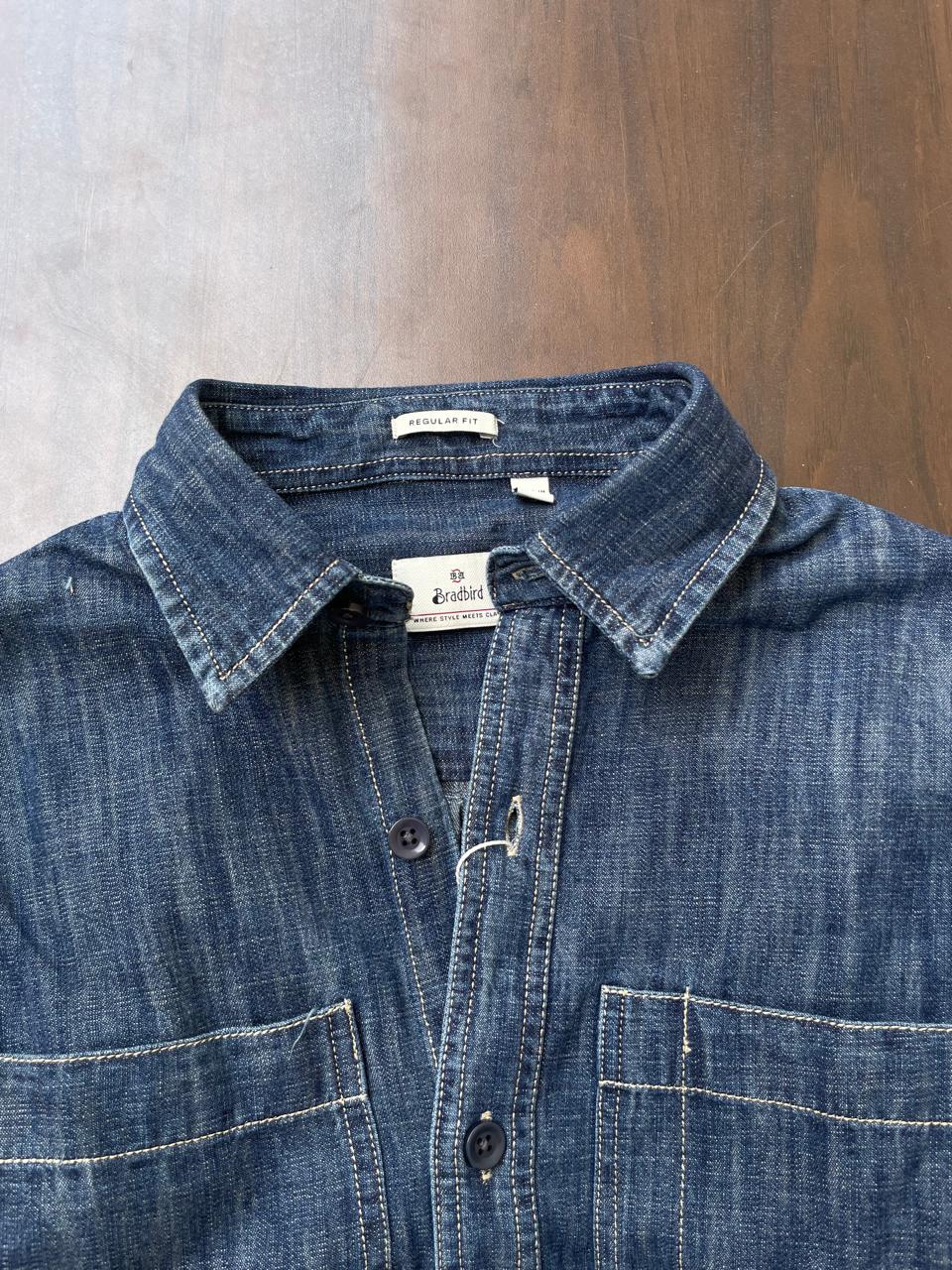 Stonewash indigo denim shirt close-up with collared neck and button front