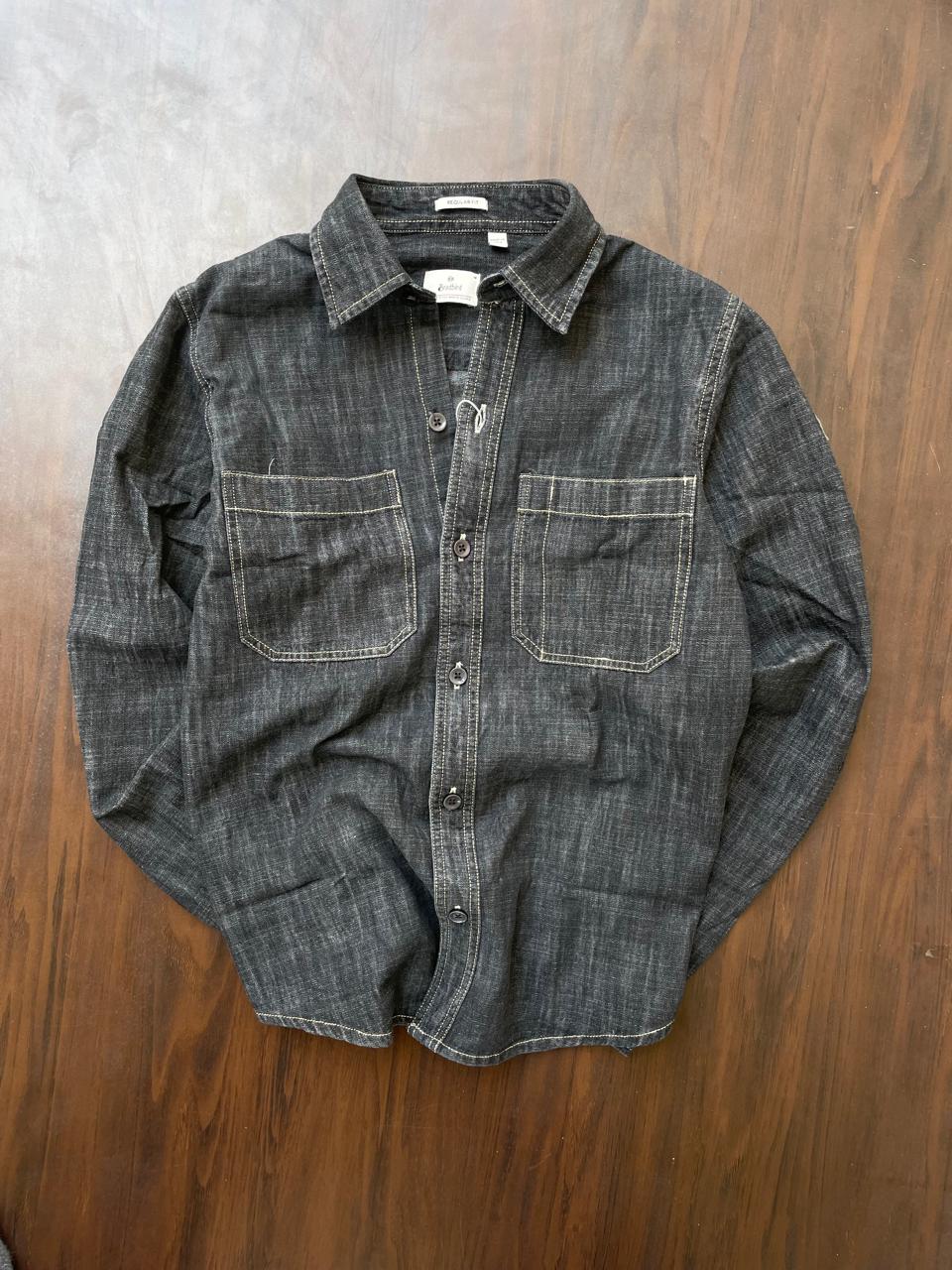 Dark wash slub denim button-up shirt with two chest pockets, long sleeves