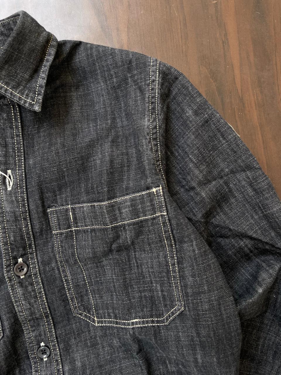 Dark slub denim shirt chest pocket with contrast stitch and button placket edge