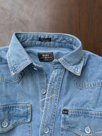 Light blue denim shirt collar and button placket, with brand label