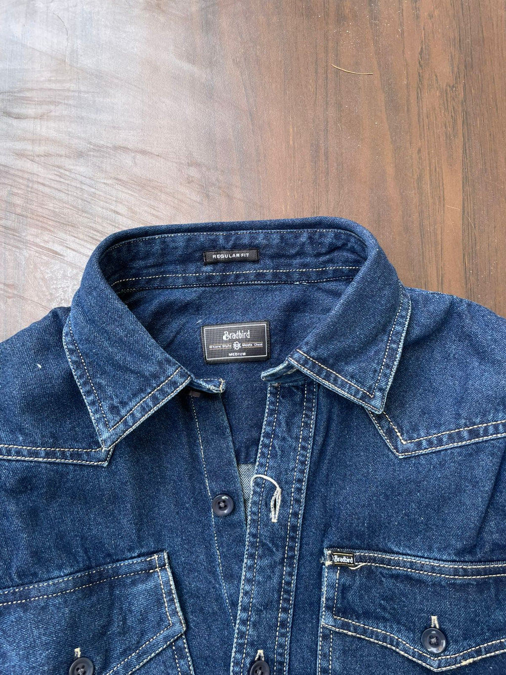 Blue denim western-style shirt neckline with label and button placket detail