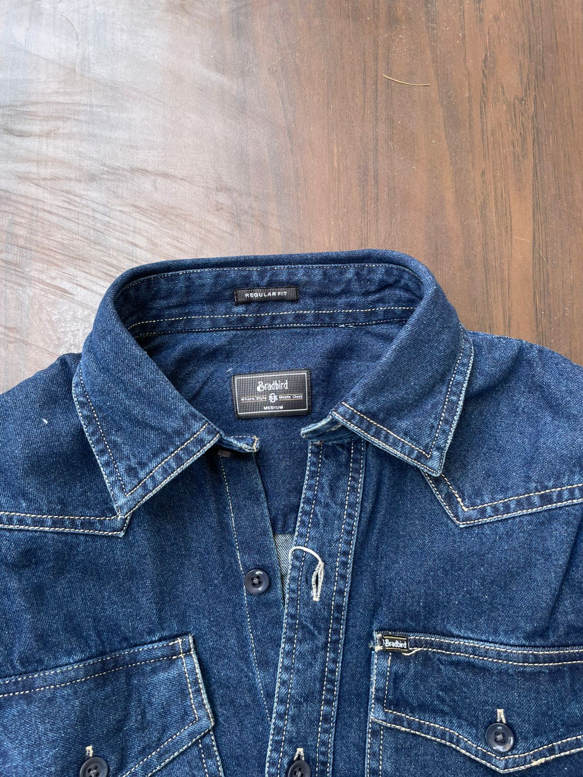Blue denim western-style shirt neckline with label and button placket detail