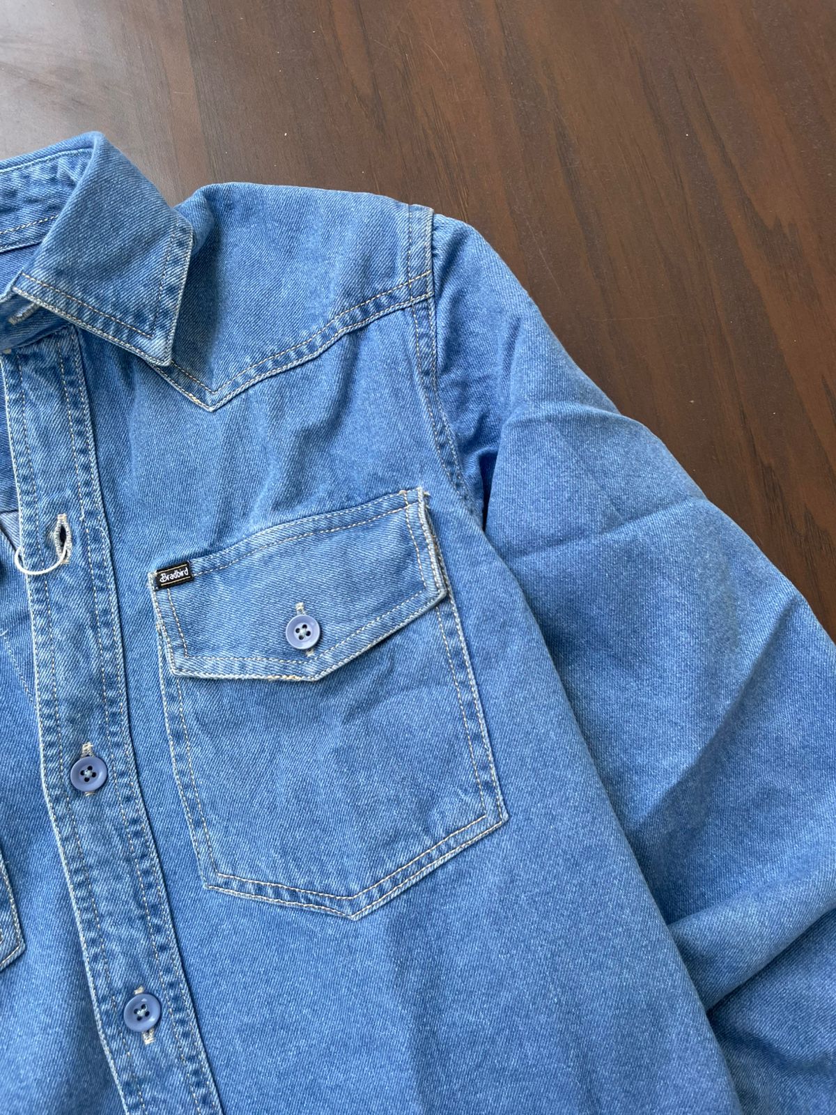 Medium-wash denim western shirt with pointed yoke and front button placket