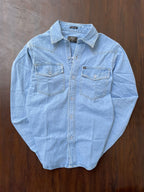 Light wash denim over-shirt laid flat, snap-button placket and chest pockets