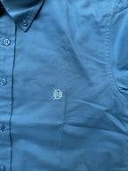Indigo-blue textured oxford fabric with small tonal monogram on chest panel.
