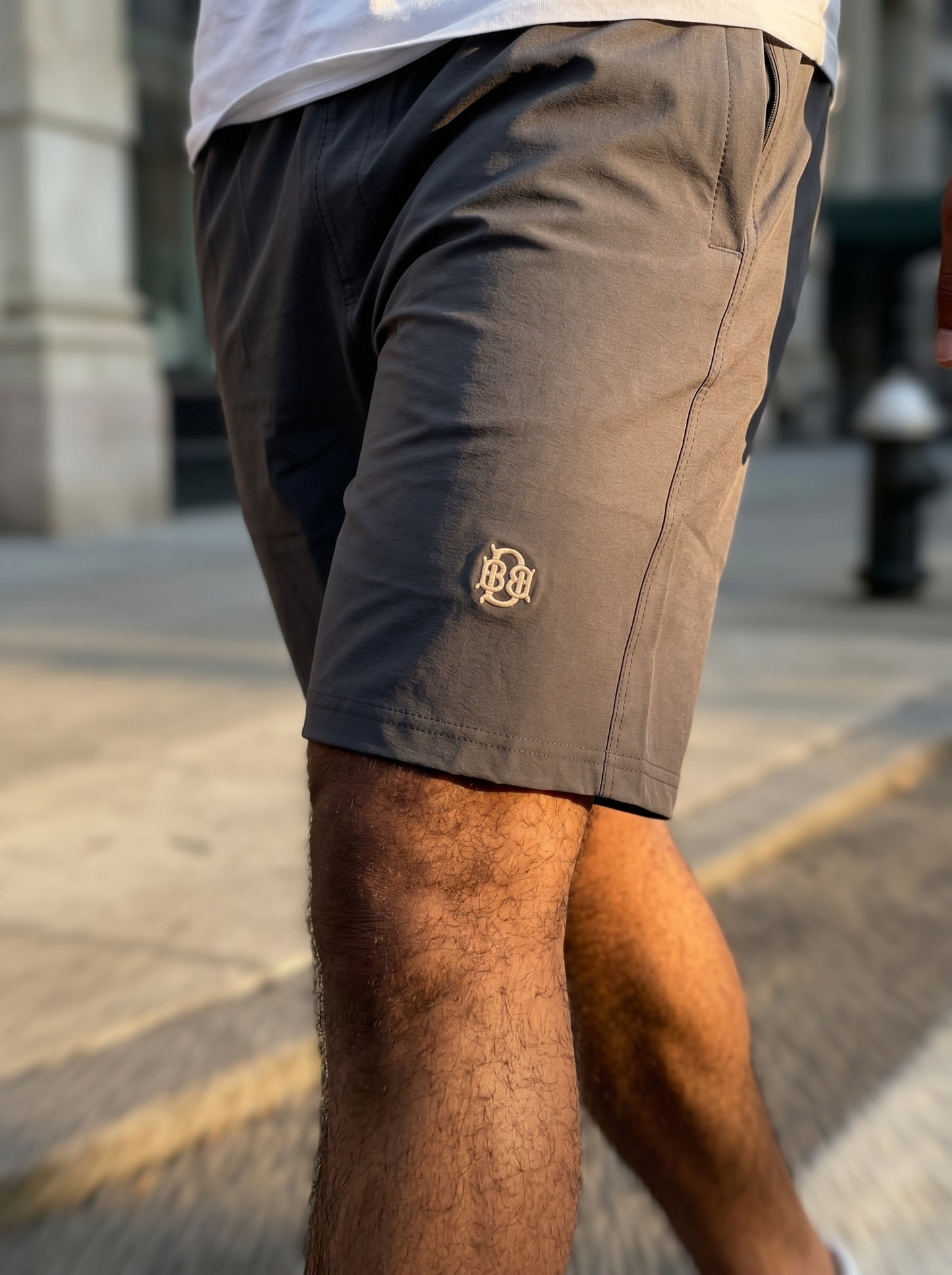 Dark grey lightweight shorts with side logo and curved front seam